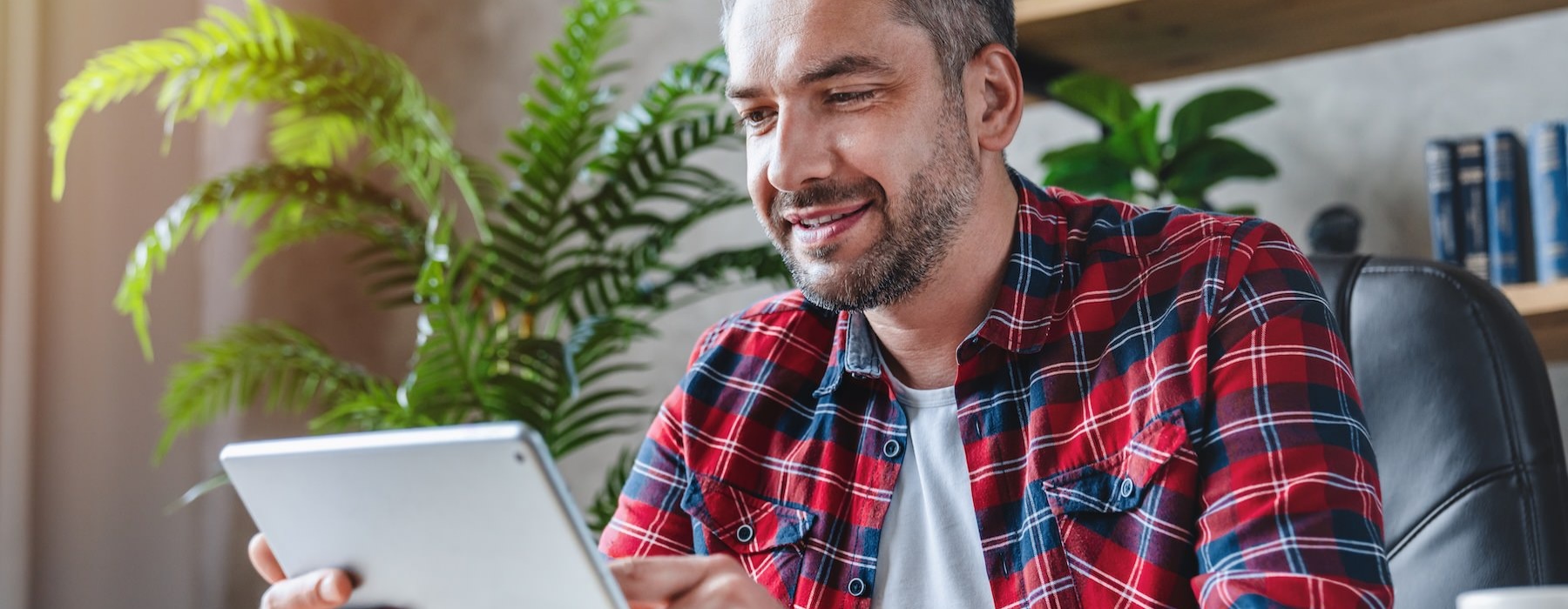 a man scrolling on a tablet