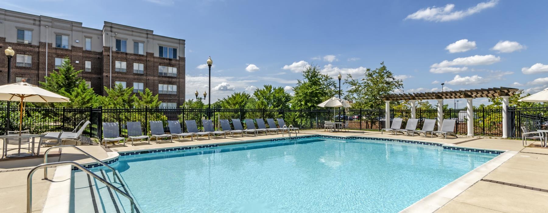 a swimming pool with a building in the background