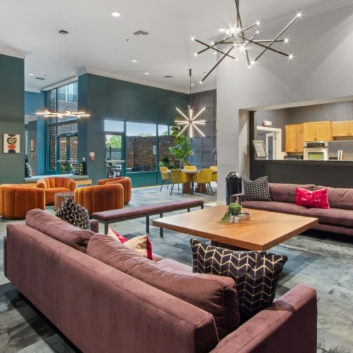 a clubroom with couches, tables and chairs