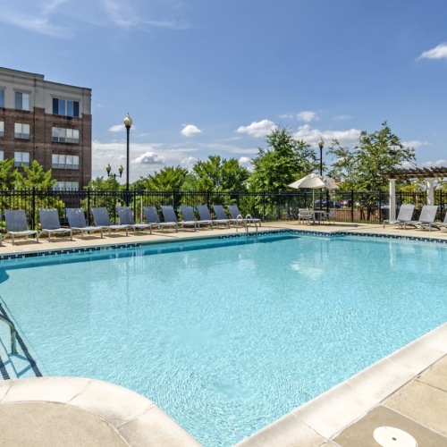 a swimming pool with lounge chairs