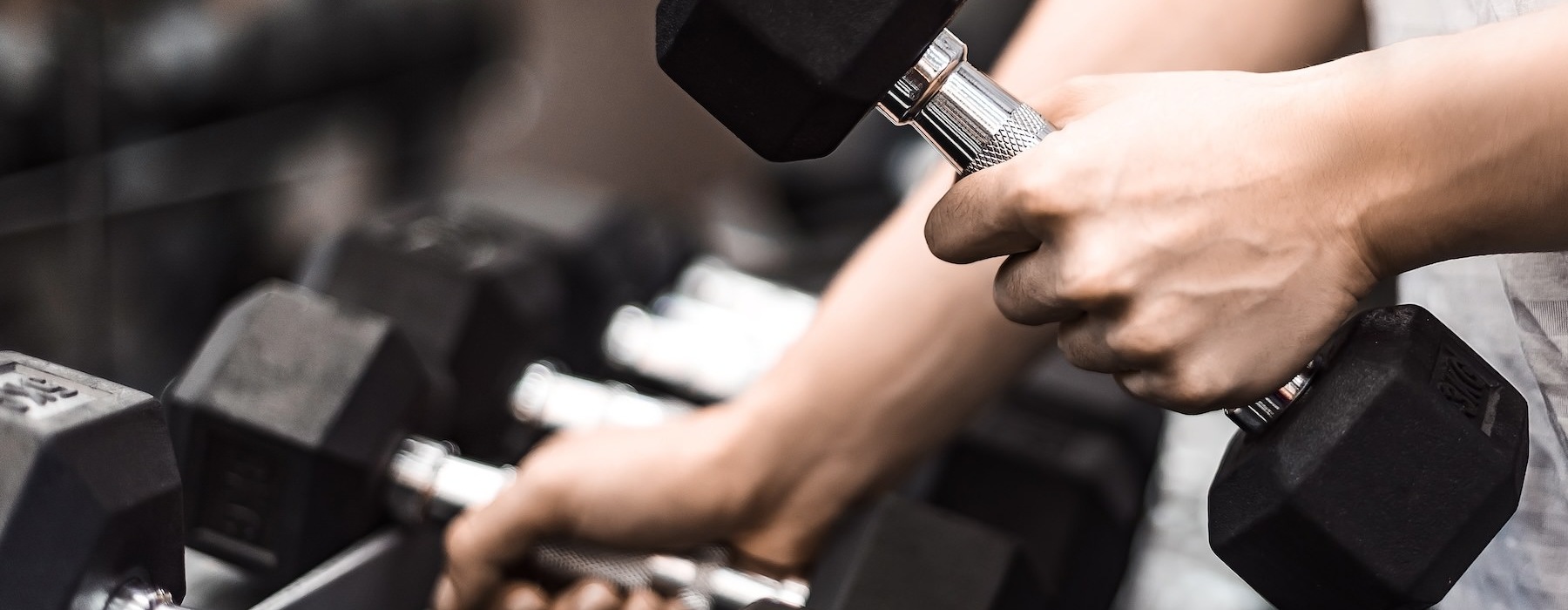 someone picking up dumbells